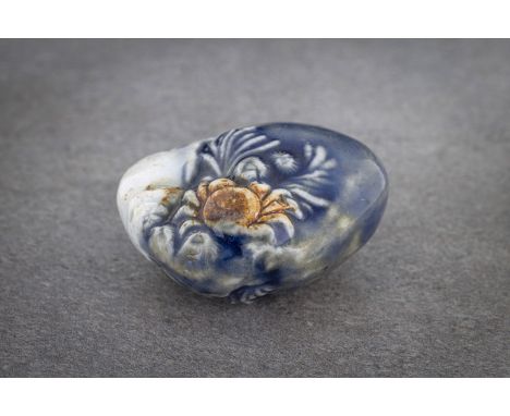 A RARE HIRADO PORCELAIN NETSUKE OF A CRAB, SHELL AND SEAWEED Unsigned, Japan, 19th century, Edo period (1615-1868) In the sha
