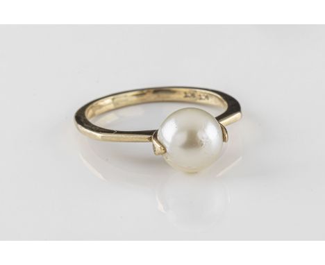 a 9ct yellow gold pearl ring the 7.5mm pearl in a spinning setting, on a canted shank, ring size M, total gross weight approx