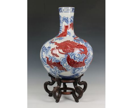 A large Chinese porcelain bottle vase 19th / 20th century, ovoid body rising from recessed unglazed base to a slightly taperi