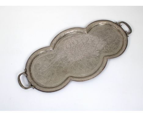 A large Indian Mughal twin handle white metal tray shaped cartouche form, extensively engraved,18½in. x 8½in' wide.