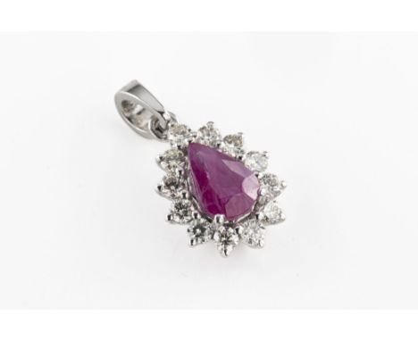 An 18ct white gold ruby and diamond pendant the central pear cut ruby approx 0.61ct, surrounded by eleven round brilliant cut