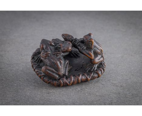 WELL DETAILED AND UNUSUAL WOOD NETSUKE OF THREE TOADS ON A LOTUS LEAF Signed, possibly Meigyoku, japan, probably early 20th c