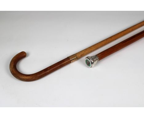 A Columbian pine walking cane the finial set with enamel Jersey penny (1/12 of a Shilling) 36in. (91.4cm.) long, together wit