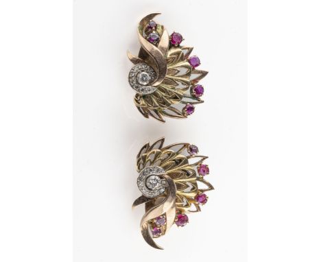 A pair of 1950s bi-coloured gold diamond and ruby ear clips, each set with a central round brilliant-cut diamond approx 0.06c