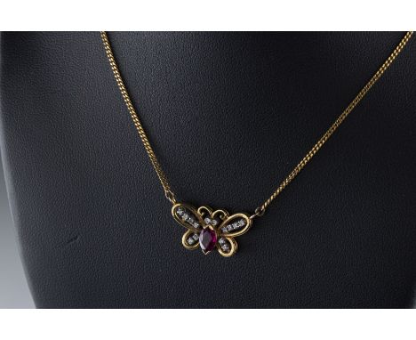 An 18ct yellow gold ruby and diamond butterfly pendant necklace set with a marquise cut ruby and fourteen round cut diamonds,