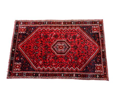 A Persian Qashqai wool rug with lozenge medallion repeated to spandrels, 104 x 74in. (264 x 187cm.).*Fringes gone, light wear