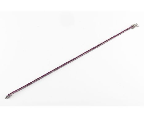 An 18ct white gold and ruby line bracelet set with round cut rubies approx 3.21cts, total gross weight 7.3g. *very good condi