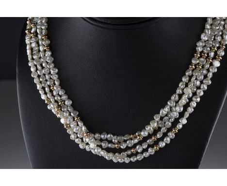 A 9ct yellow gold and freshwater pearl four strand necklace with yellow gold spacers, approx 77cm long, total gross weight ap