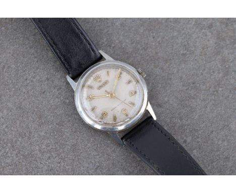 A Mid-Century Rolex Shock Resisting stainless steel mid size manual wind wrist watch 1950s, the 24.5mm. silvered dial with mi