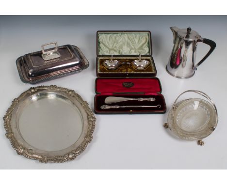 A collection of silver plated items comprising an oval gadrooned tray incorporating a wooden cutting board, a serving dish wi