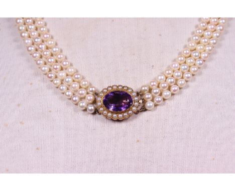 A 3 row cultured pearl necklace with amethyst and pearl clasp in 9ct. gold.