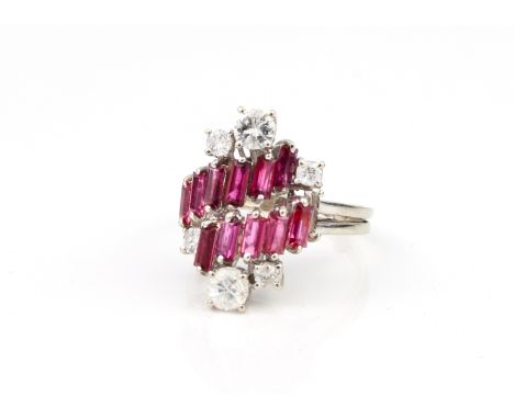 A vintage 18ct white gold, ruby and diamond modernist style ring hallmarked '18CT', with two stepped twist rows of baguette c