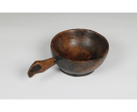 Treen. A carved wooden grain ladle 10½in. (26.7cm.) long together with a wooden scoop. (2)