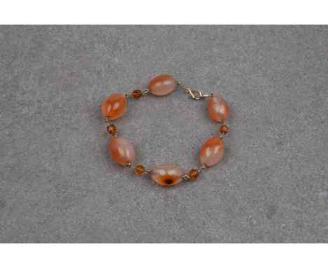 A vintage 9ct gold, amber and agate bead bracelet the ovoid agate beads joined by gold and faceted amber bead links, with hoo