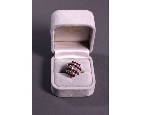 A ruby and diamond cluster dress ring approx. 1.37ct diamonds, set in white and yellow gold.