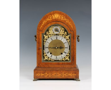 A 20th century arch top mahogany cased mantle clock the face having gilt metal spandrels, matted center, silvered chapter rin