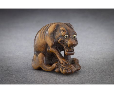 A GOOD TOYOMASA SCHOOL WOOD NETSUKE OF AN EMACIATED WOLF EATING A HAUNCH OF VENISON School of Naito Toyomasa (1773-1856), sig