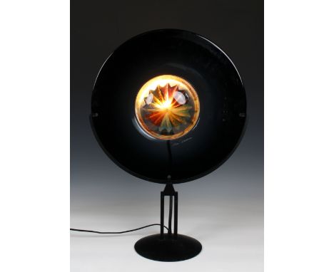 A Murano glass disc on stand table lamp the outer deep purple disc encompassing a clear glass centre with star/sun, signed, 1