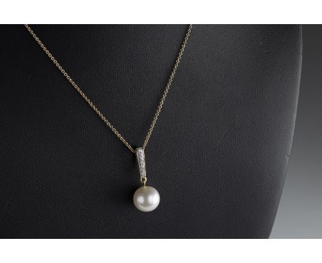 A 9ct yellow gold freshwater cultured pearl and diamond pendant the 9.4mm pearl suspended from a diamond set bale, total diam