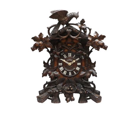 A Black Forest Striking Cuckoo Table Clock, circa 1890, carved to crest surmounted by a bird, case front with carved leaf and