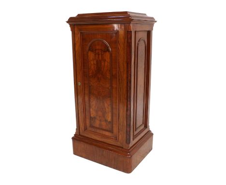 A Victorian Figured Walnut Side Cabinet, circa 1880, the moulded staged top above a central cupboard door with arched panel e