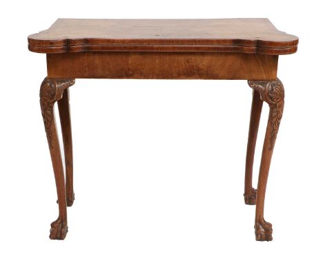 A George II Walnut, Crossbanded and Featherbanded Foldover Card Table, mid 18th century, the quarter-veneered top with hinged