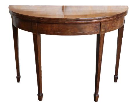 A George III Mahogany, Boxwood and Ebony-Strung Foldover Card Table, circa 1800, the hinged leaf enclosing a green baize-line