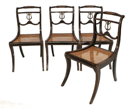 A Set of Six Regency Ebonised, Gilt Metal and Cane-Seated Dining Chairs, early 19th century, the bobbin-turned and reeded top