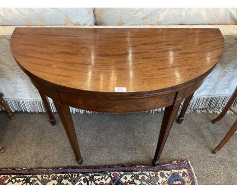 A George III Mahogany, Boxwood and Ebony-Strung Foldover Card Table, circa 1800, the hinged leaf enclosing a green baize-line