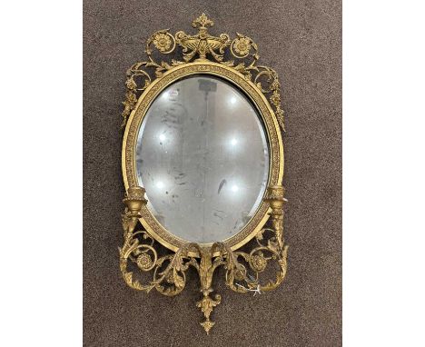 A Victorian Gilt and Gesso Girandole Mirror, 2nd half 19th century, the later bevelled glass mirror plate within a stiff leaf