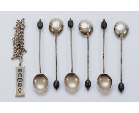 A set of six silver coffee spoons, Birmingham 1936, together with a silver ingot on chain, Sheffield 1977, 65gm. (7)
