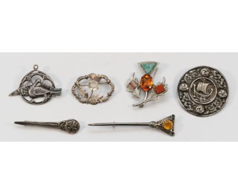 A Scottish silver and gemset thistle brooch, 45mm, three 925 silver brooches, largest 75mm, and two sterling silver brooches,