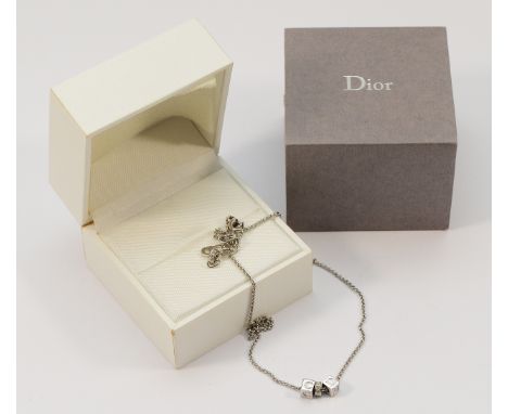 Christian Dior, a silver gilt chain with three pendants, with box, 5g