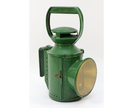An unmarked green three aspect railway hand lamp- complete with burner