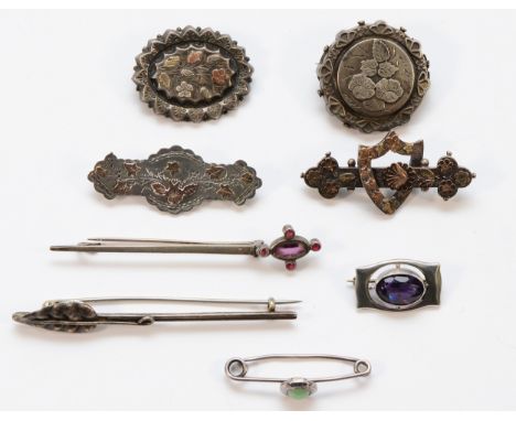 Charles Horner, a silver and amethyst glass brooch, Chester 1914, four Victorian silver brooches, Birmingham 1891 and 1898, w