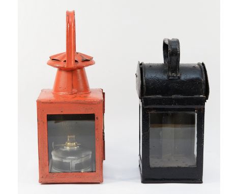 A red BR(M) hand lantern (Complete with burner) and a black unmarked lantern (No burner)