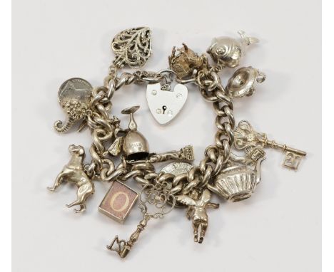 A 925 silver charm bracelet with approx 18 charms to include a heart shaped padlock clasp, a Statue of Liberty charm and a fi