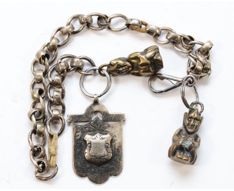 A silver watch fob on chain, markings worn, with two brass Goblins attached, total weight 57gm.