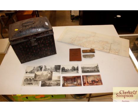 A vintage tin trunk and contents to include a map, whistle, etc.
