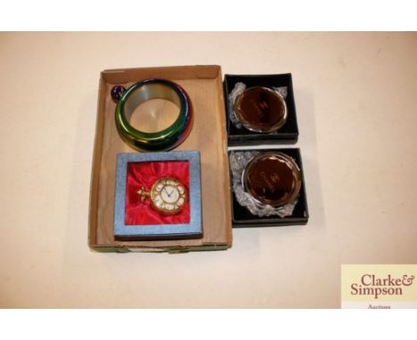 Two boxed Chanel handbag mirrors; a boxed pocket watch; and a perfume bottle 