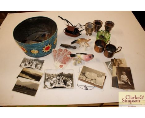 An old biscuit tin and miscellaneous contents including coinage, two porcelain birds, camera light meter, platedware etc.
