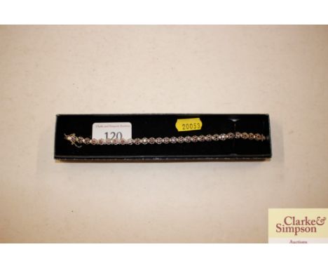 A boxed white metal and amethyst coloured bracelet