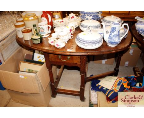 An antique oak gate leg dining table