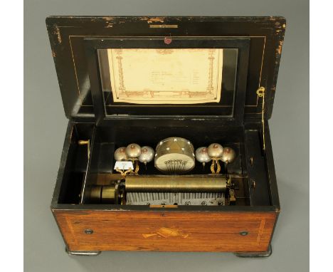 A Victorian rosewood music box, bells in sight and drum, playing six airs. Cylinder length 27 cm, case  61 cm x 34 cm x 26 cm