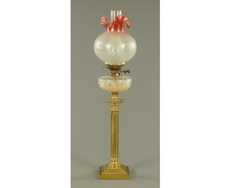 A Victorian brass Corinthian column oil lamp, with etched and ruby glass shade.  Height including chimney 80 cm.