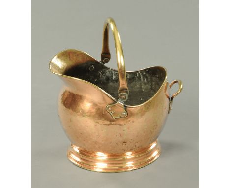A 19th century copper coal helmet, with loop handle. 