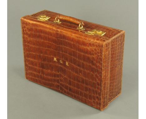 A vintage reptile skin suitcase, circa 1930, initialled "MGH".     CONDITION REPORT:  Brass locks stamped WB within a circle.