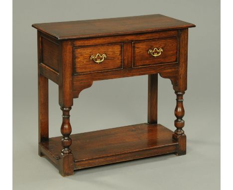 An oak side table, with pegged top, two frieze drawers, turned legs and low shelf.  Width 81.5 cm.    CONDITION REPORT:  Widt