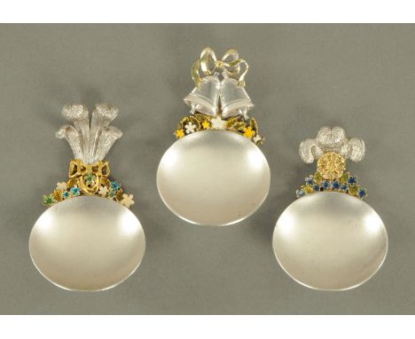 Three Stuart Devlin caddy spoons, Prince of Wales plume, London 1984, bells, London 1986, and 1985 (see illustration).   COND