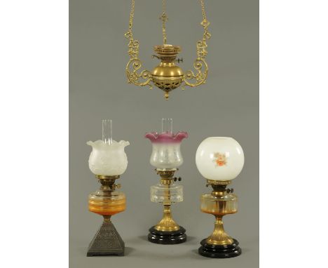 Three antique oil lamps, and a hanging oil lamp.